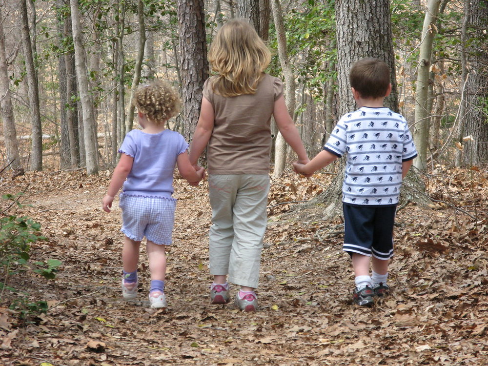 Three Children going For A Walk Holding Hands